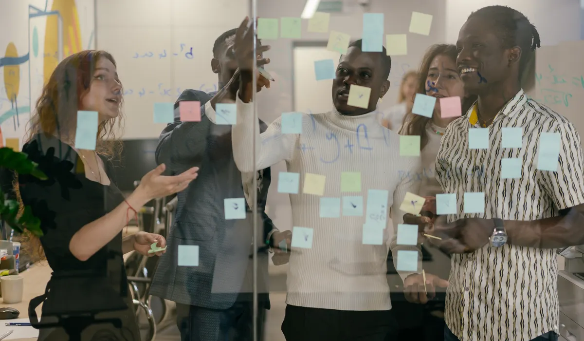 Équipe produit organisant les étapes de développement d’un MVP sur un mur de post-it